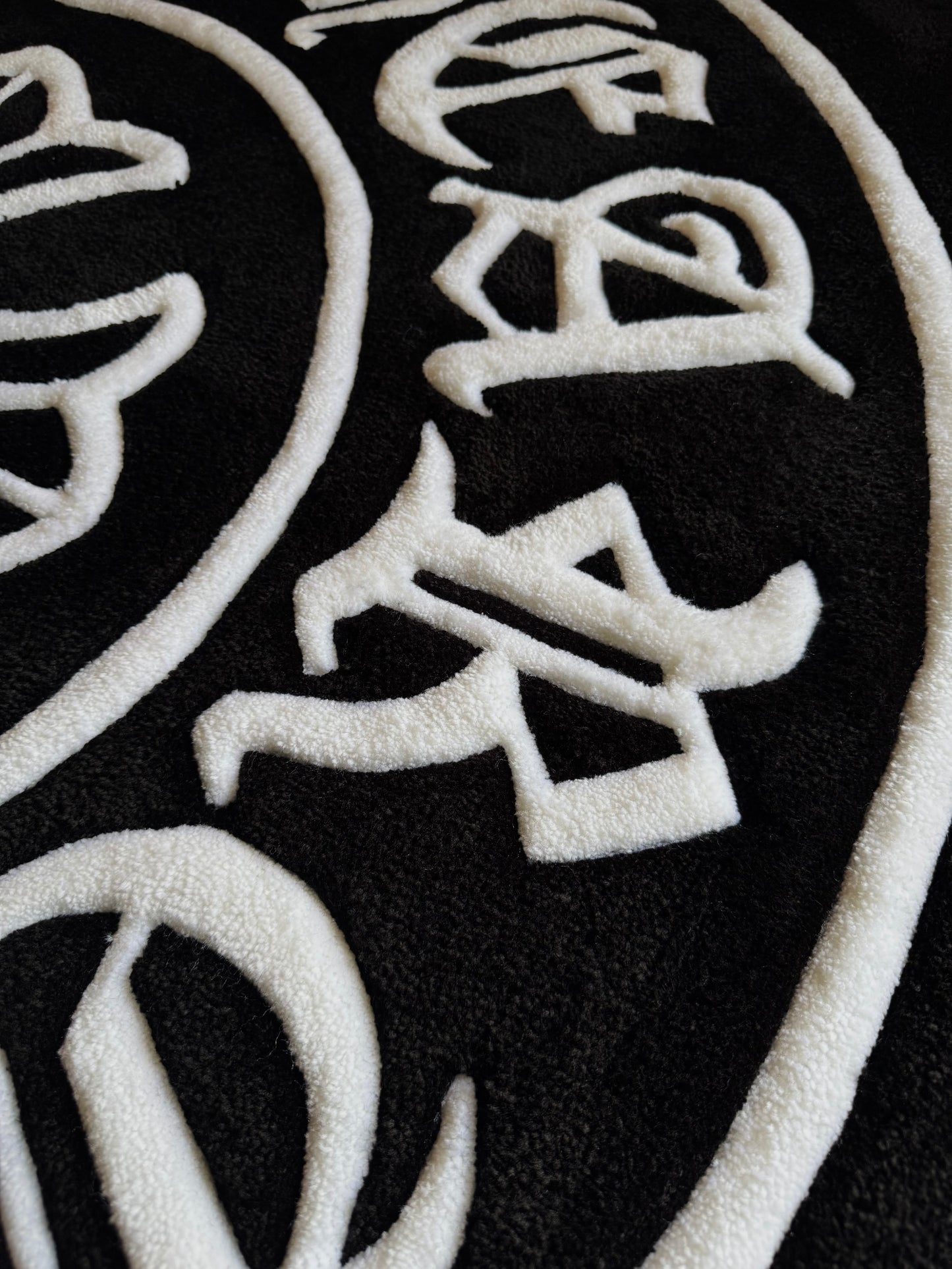 Chrome Hearts-inspired tufted rug featuring bold gothic cross design — a statement collectible for streetwear enthusiasts and luxury interiors
